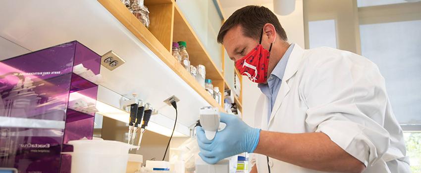 Kevin Lee, Ph.D., assistant professor of research, works in a lab at the Mitchell Cancer Institute.